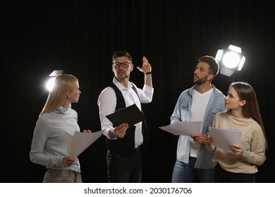 Professional Actors Reading Their Scripts During Rehearsal In Theatre