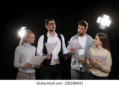 Professional Actors Reading Their Scripts During Rehearsal In Theatre