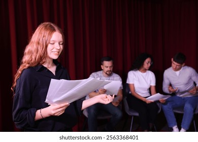 Professional actors reading their scripts during rehearsal in theatre - Powered by Shutterstock