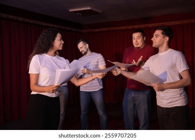 Professional actors with their scripts rehearsing in theatre - Powered by Shutterstock