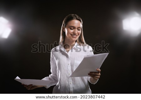 Professional actress reading her script during rehearsal in theatre