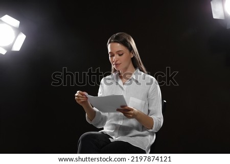 Professional actress reading her script during rehearsal in theatre