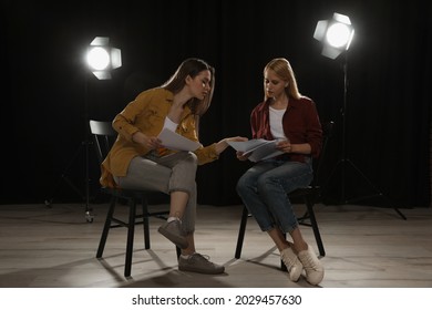 Professional Actresses Reading Their Scripts During Rehearsal In Theatre