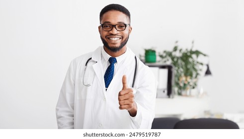 Professional African Doctor Showing Thumb Up In Front Of Medical Team In Hospital - Powered by Shutterstock