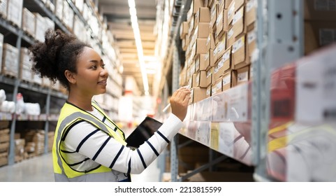 Professional African Female Worker using 
technology.Checks Stock Inventory with Digital Tablet Computer Walks in the Retail Warehouse full of Shelves with Goods.Working Delivery, Distribution Center. - Powered by Shutterstock