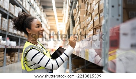 Professional African Female Worker using 
technology.Checks Stock Inventory with Digital Tablet Computer Walks in the Retail Warehouse full of Shelves with Goods.Working Delivery, Distribution Center.
