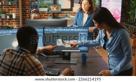 Professional agency workers designing industrial prototype on creative software, using 3d render interface. Young technicians working on mechanical product asset, machinery production.