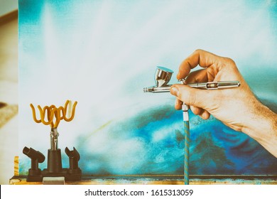 Professional airbrush in artist hand