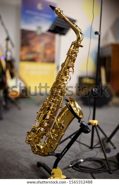 Professional alto Saxophone on the stand on\
scene after (before) the concert or\
repetition