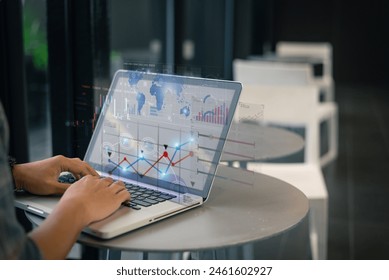 A professional analyzes complex data charts on a laptop in a sleek office environment, showcasing technology and analytics.