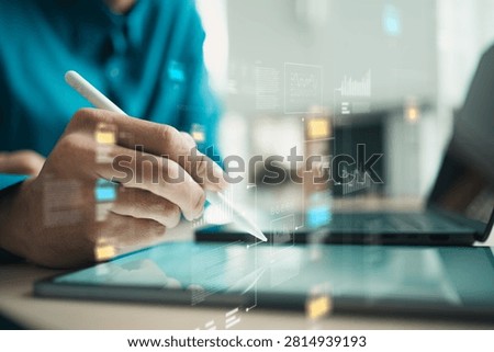 Professional analyzing big data dashboards on a tablet with digital charts and AI insights for smarter business decisions and analytics.