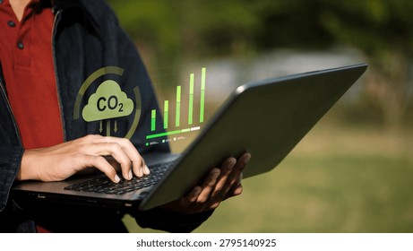 Professional analyzing carbon emissions data and ESG performance on a laptop. Concept of carbon footprint tracking, sustainability reporting, climate analytics, net zero strategy, environmental compliance, and green business management.