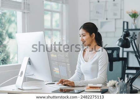 Professional analyzing complex data with a futuristic holographic display interface over a desktop, demonstrating cutting-edge technology in business analytics.