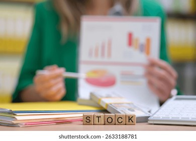 A professional is analyzing stock performance using charts and financial data to gain strategic insights