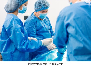 Professional anesthesiologist doctor medical team and assistant preparing patient to gynecological surgery performing operating with surgery equipment in modern hospital operation emergency room - Shutterstock ID 2188050919