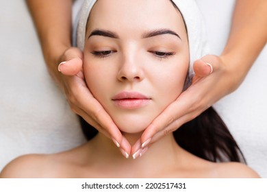 Professional anti-aging facial massage. Action. Relaxing facial treatment at Spa. Relaxing and rejuvenating facial massage for women - Shutterstock ID 2202517431