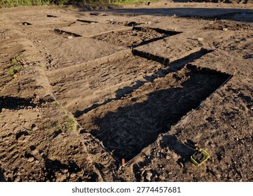 professional archaeological excavation in progress. sharp, clean edges and geometric patterns soil aren't accidental systematic method used to reveal history hidden beneath surface. The Wheeler-Kenyon Method​grid structure checkered archaeological. By leaving walls of earth known as baulks between excavated squares,
