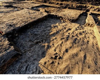 professional archaeological excavation in progress. sharp, clean edges and geometric patterns soil aren't accidental systematic method used to reveal history hidden beneath surface. Wheeler-Kenyon Method​grid structure checkered archaeological. By leaving walls of earth—known as baulks between excavated squares, basket. findings