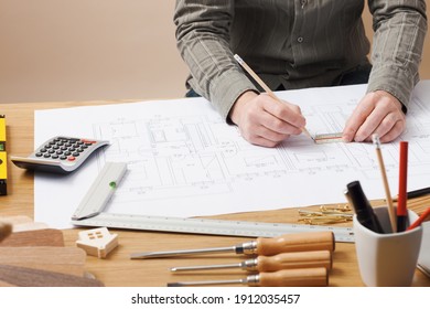 Professional Architect And Construction Engineer Working At Office Desk Hands Close-up, He Is Drawing On A Building Project With A Pencil And A Ruler