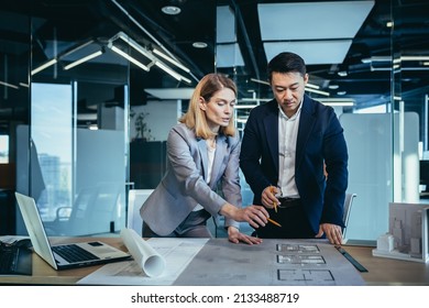 professional architect designer structural engineer team colleagues working office looking computer screen discussing building plan design project draft drawing. team multiracial business developers