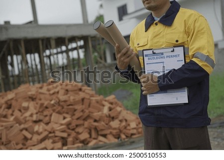 Professional architect engineer with hard hat and blueprint at building construction site house building permit background. Architects looking at blueprints. Construction and engineering industry