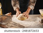 professional artisan baker chef is making loaf of dough, cooking pizza and other pastries in pizzeria kitchen. Close-up