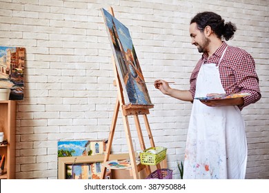 Professional artist painting a picture on canvas