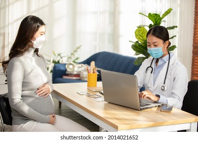 Professional Asian doctor woman consulting pregnant patient,Smart Doctor wearing white coat with stethoscope talking to patient at hospital,Doctor and Pregnancy Patient Concept