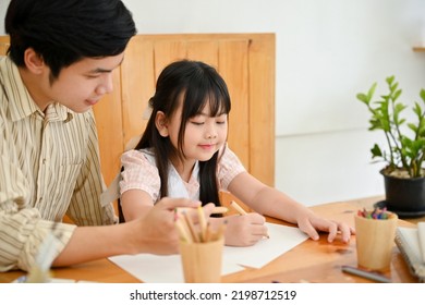 Professional Asian Male Art Teacher Or Tutor Teaching A Cute Young Girl Student To Draw And Paint With Watercolor.