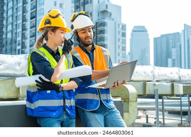 Professional Asian man and woman teamwork engineer and foreman using laptop working outdoor at construction site building rooftop. Architecture inspector inspect building exterior structure system. - Powered by Shutterstock