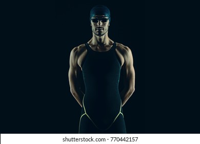 Professional Athlete Swimmer Studio Portrait Against Black Background. Blue Tone Color Correction.