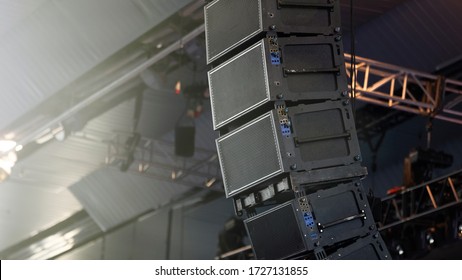 Professional audio equipment suspended from the ceiling. Audio speakers for events