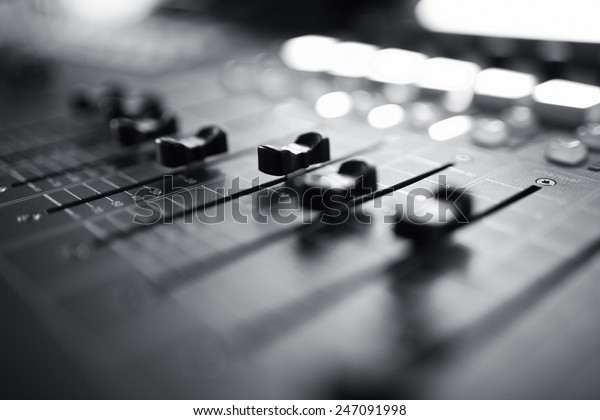 Professional audio mixing\
console with faders and adjusting knobs,TV equipment Black and\
White selective\
focus