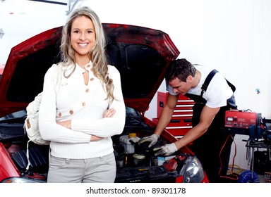 Professional Auto Mechanic And Woman In Auto Repair Shop. Garage.