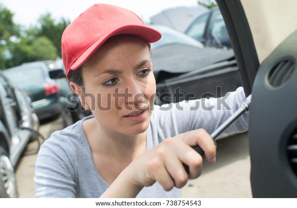professional auto woman mechanic and man repair\
auto outdoors