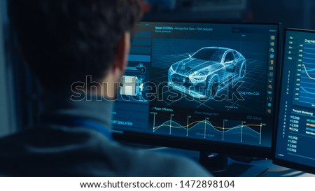 Professional Automotive Graphic Designer is Working on 3D CAD Software Rendering Electric Concept Car and Calculating its Efficiency in a High Tech Innovative Laboratory with a Prototype.
