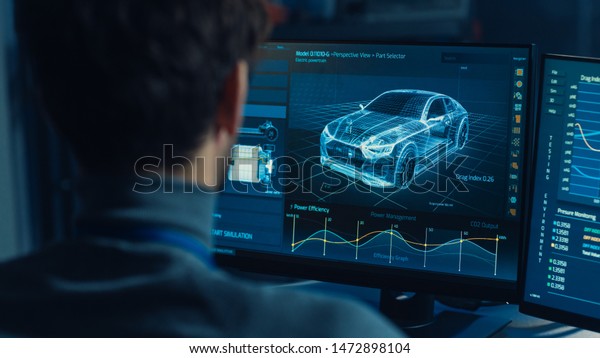 Professional
Automotive Graphic Designer is Working on 3D CAD Software Rendering
Electric Concept Car and Calculating its Efficiency in a High Tech
Innovative Laboratory with a
Prototype.