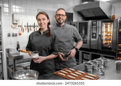 Professional bakers preparing fresh baguette in small bakery - Powered by Shutterstock