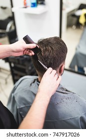 Professional Barber Doing A Haircut To A Male Client. Selective Focus.