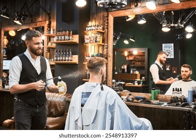 Professional barber spraying aftershave lotion on client's nape. Back view of fresh haircut from experienced hairdresser. Male hairstylist using special equipment for styling. - Powered by Shutterstock