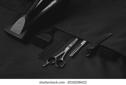 Professional barber tools, in the pocket, black stylist apron horizontal - Powered by Shutterstock