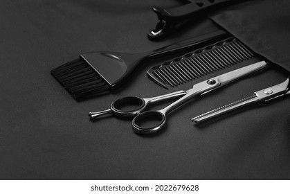 Professional barber tools, in the pocket, black stylist apron, horizontal, no people, - Powered by Shutterstock