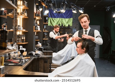 Professional barbers working on client hair in barbershop. Male hairstylists cutting hair in modern ambiance, with rustic wooden shelves stocked with various grooming products. - Powered by Shutterstock