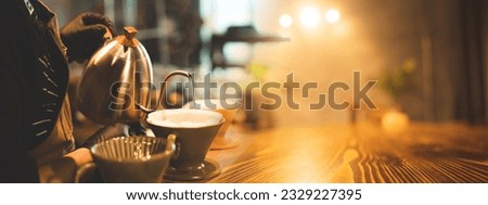 Professional barista preparing coffee using pour over maker and drip kettle. Young man making coffee. Alternative ways of brewing. Drink shop concept, copy space for artwork