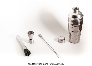 Professional bartender kit set. Cocktail shaker, bar spoon, Jigger and Muddler isolated on white background. Cocktail banner with copy space for text