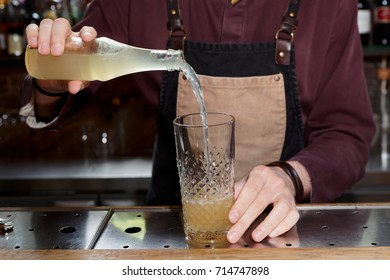 Professional Bartender Is Pouring Lemonade Or Ginger Ale In Mixing Glass