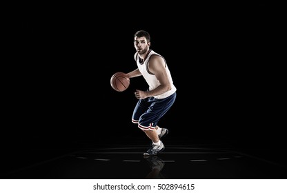 Professional Basketball Player Holding Ball On Black Background