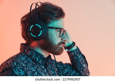 Professional Bearded Man Wearing The Headset And Shirt Listening Cerrefully - Side Profile Medium Close Up - Studio. High Quality Photo