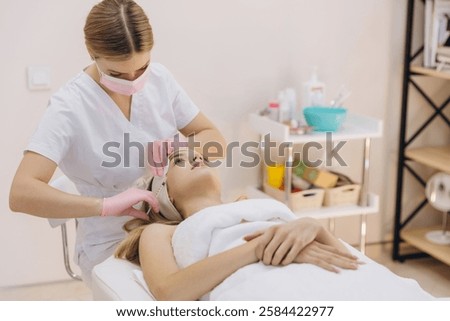 Similar – Image, Stock Photo Aesthetic Procedure Applying Botox, Hyaluronic Acid, and Tensor Threads