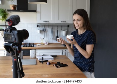 Professional beautician woman holds cream jar, expressing cosmetics product opinion, while record new video vlog on cam, for internet subscribers, create class for webinar, vlogging, skin-care concept - Shutterstock ID 2144499433